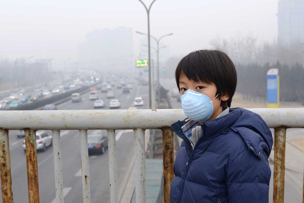 Asian Boy wearing Mouth Mask Against Air Pollution
