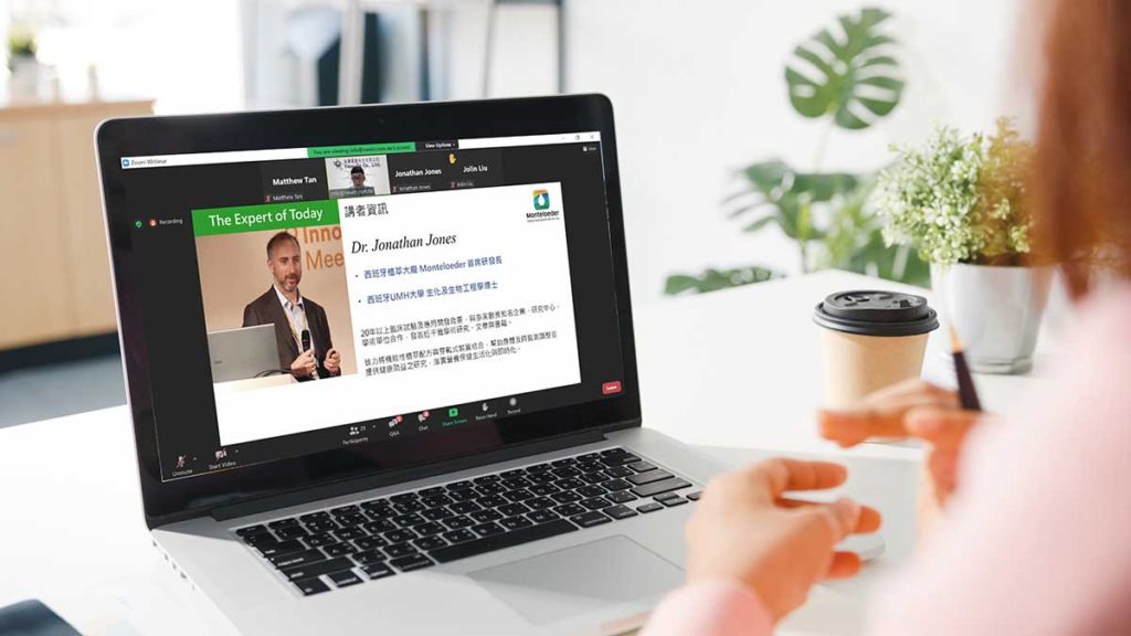 Young Asia businesswoman using laptop to watch a webinar from home at living room. Self-isolation, social distancing, quarantine for corona virus prevention.